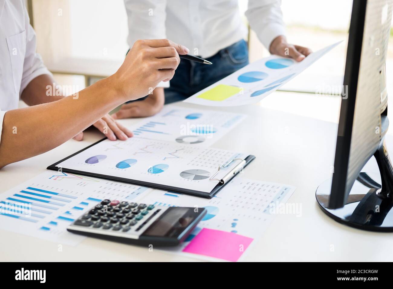 Team work process. young business managers crew working with new startup project. tablet on wood table, typing keyboard, texting message, analyse grap Stock Photo