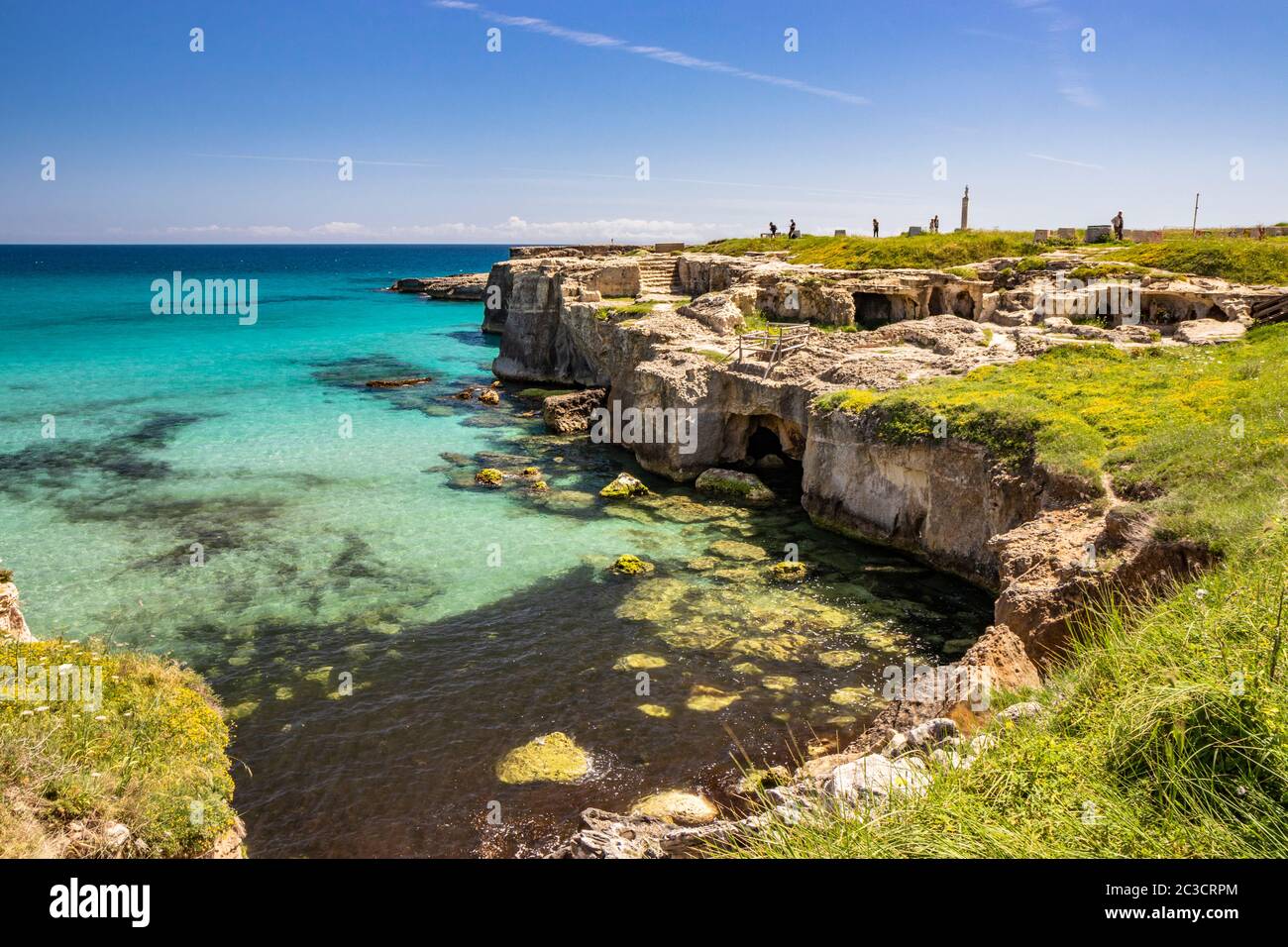 The important archaeological site and tourist resort of Roca Vecchia, in Puglia, Salento, Italy. Turquoise sea, blue sky, rocks, sun, lush vegetation Stock Photo