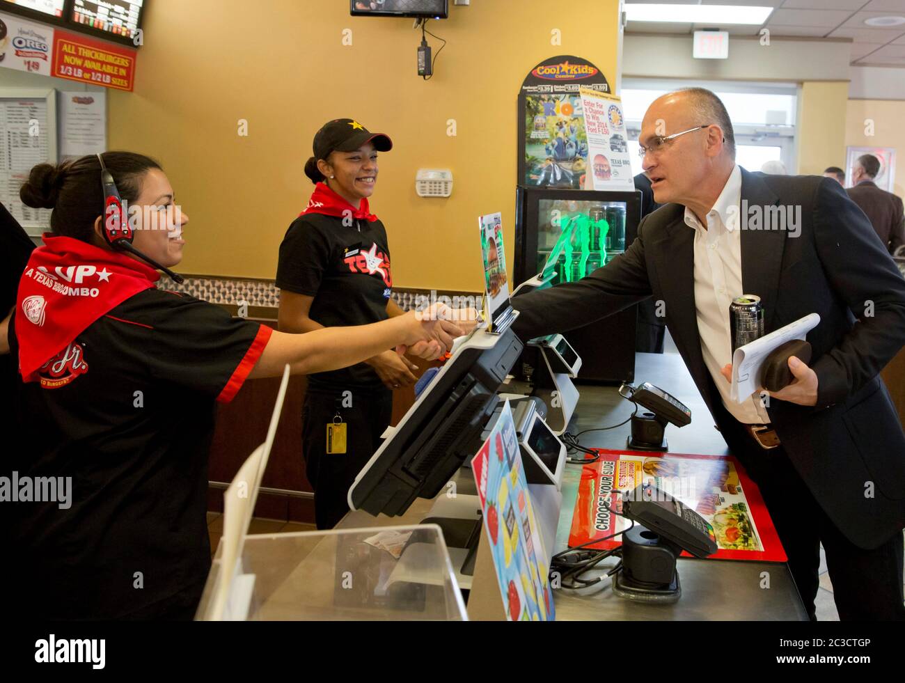 Austin Texas USA, August 6 2014: Carl's Jr. Restaurant CEO Andrew Puzder greets employees at an Austin location of the fast-food chain. Here the highly compensated executive shakes hands with low-paid hourly worker employees. ©Marjorie Kamys Cotera/Daemmrich Photography Stock Photo