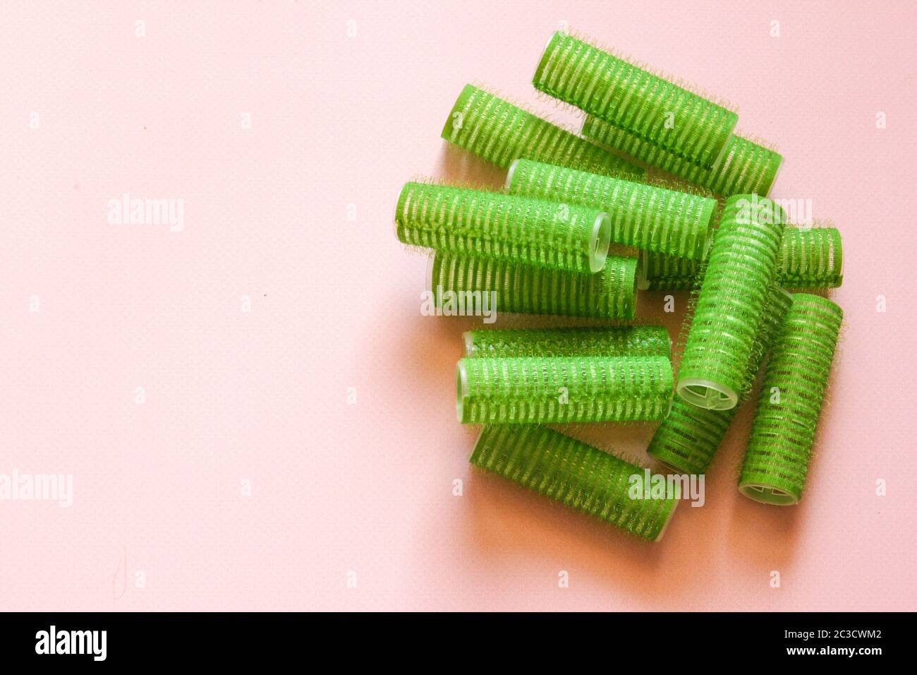 Hair culers on the pink backround. Green culers for hairdress. Stock Photo