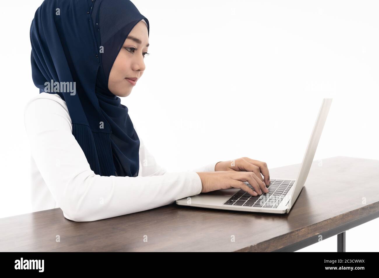 Asian young adult woman wearing hijab using laptop search and doing ...