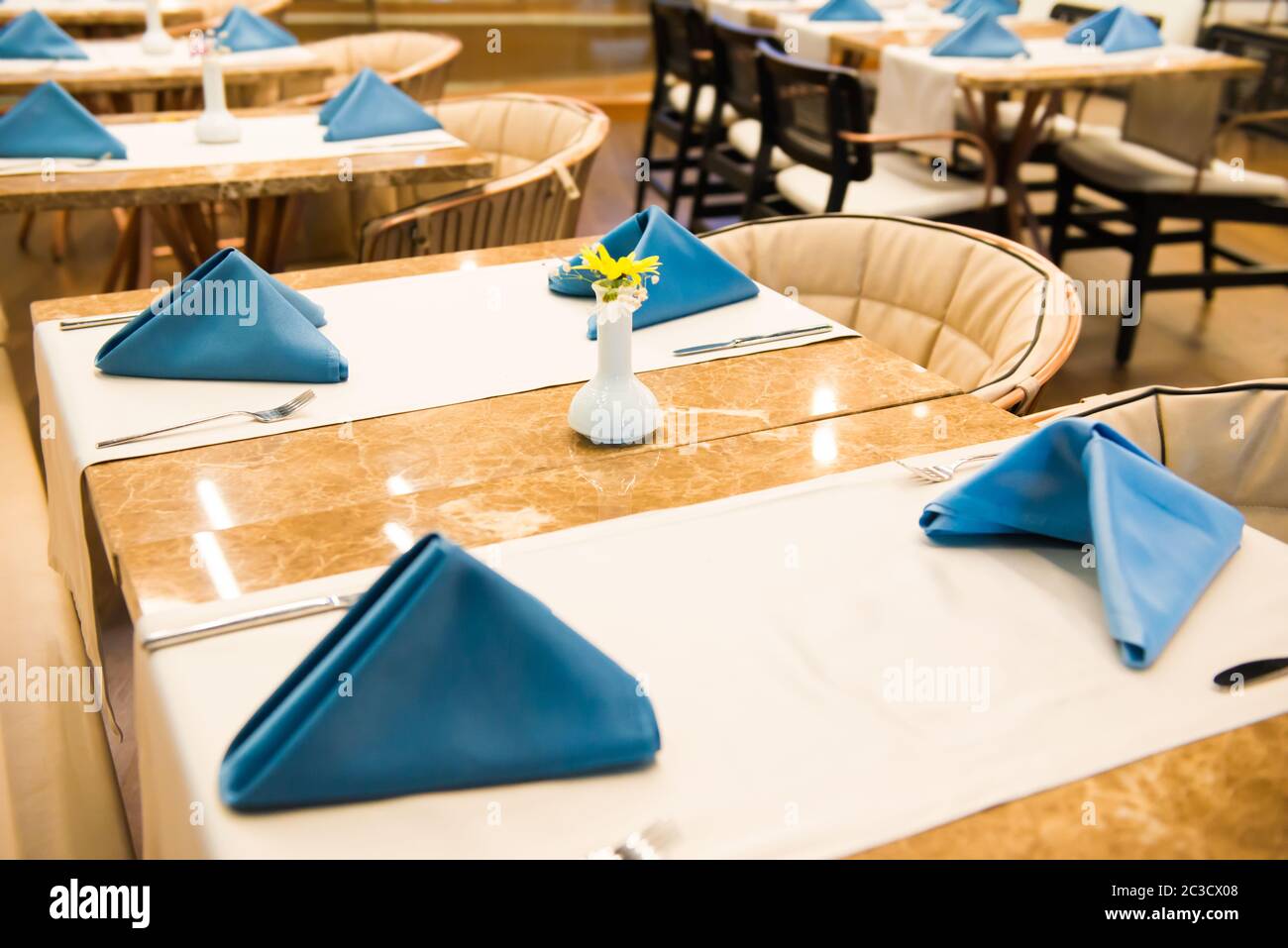 Row of empty dinner tables in restaurant Stock Photo