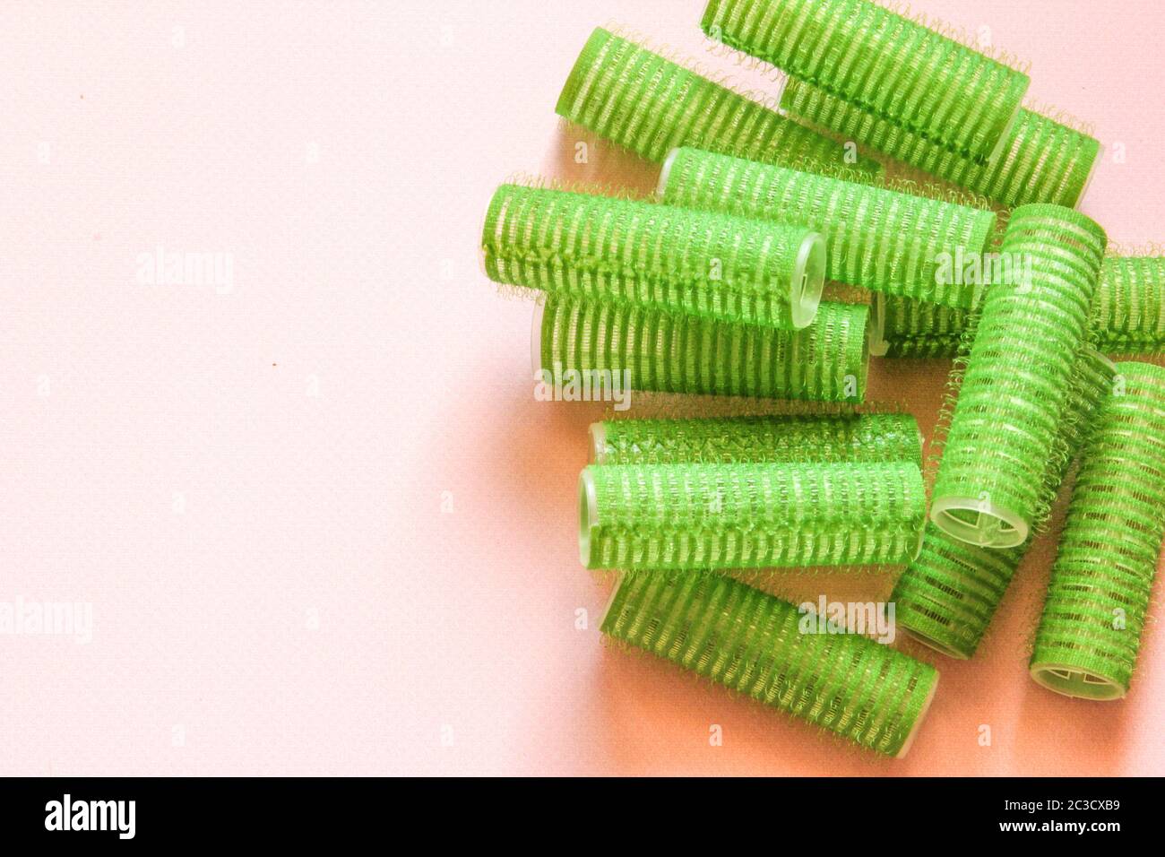 Hair culers on the pink backround. Green culers for hairdress. Stock Photo