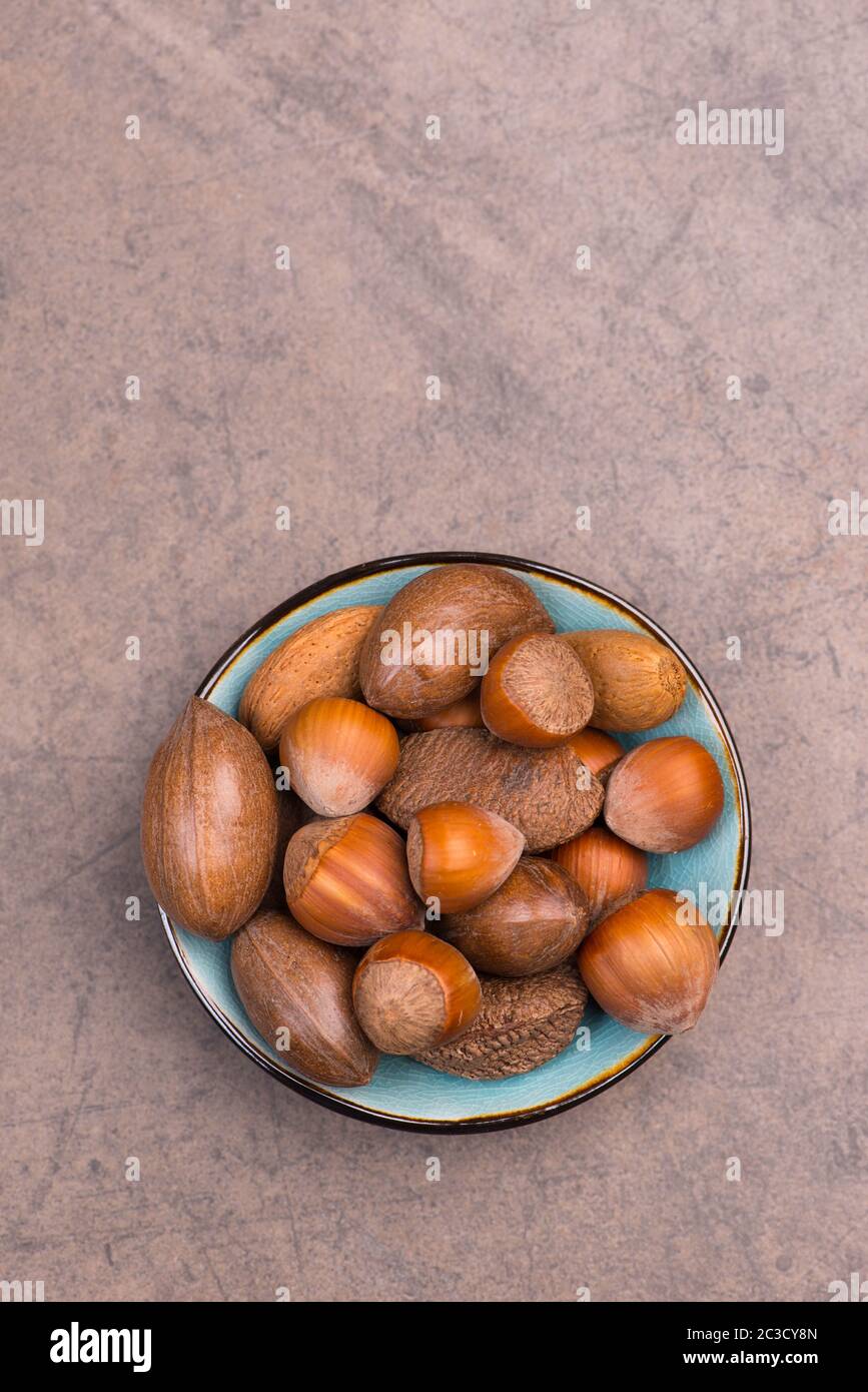 Nuts mix on a brown textured background, empty copy space Stock Photo