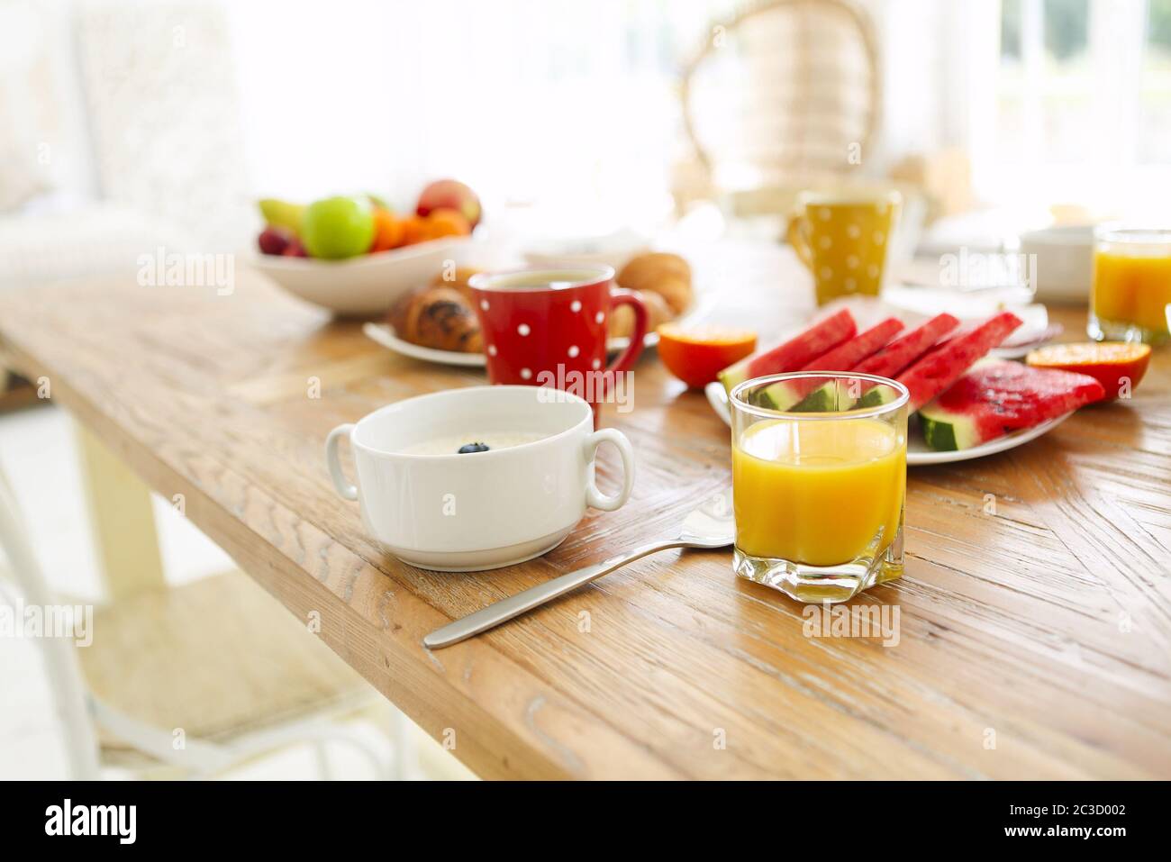Coffee with fruit, cereal and croissant on wooden table background Stock Photo