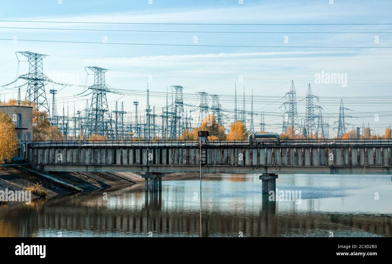 bridge over the river and the power line in Chernobyl Stock Photo