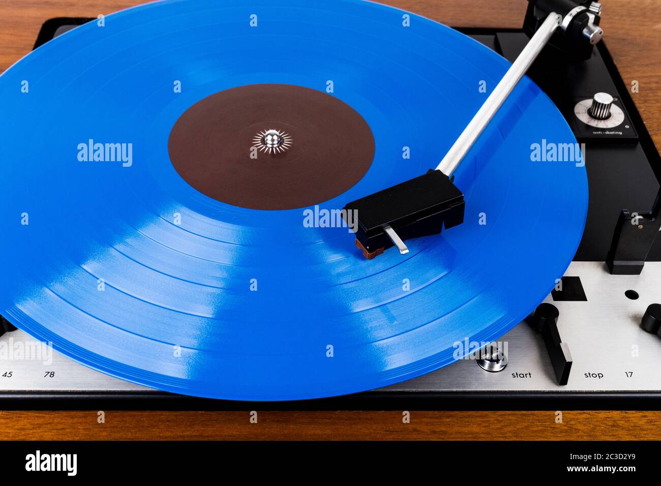 Close up of turntable cartridge on a vinyl record. Turntable playing vinyl. Needle on rotating