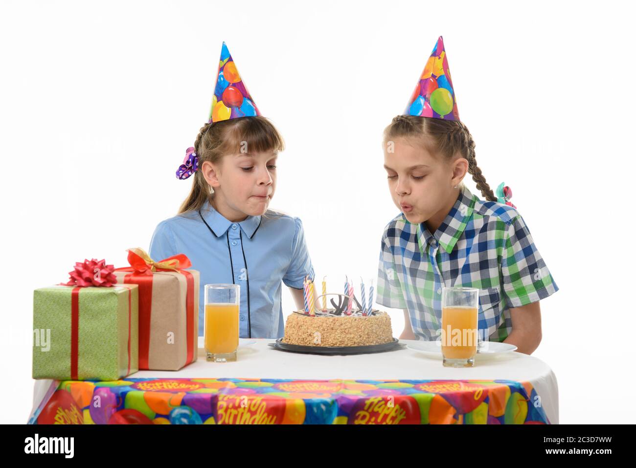 Children blow out candles on a birthday cake Stock Photo Alamy