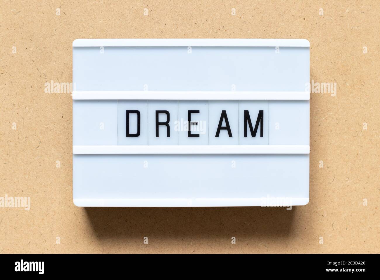 White lightbox with word dream on wood background Stock Photo