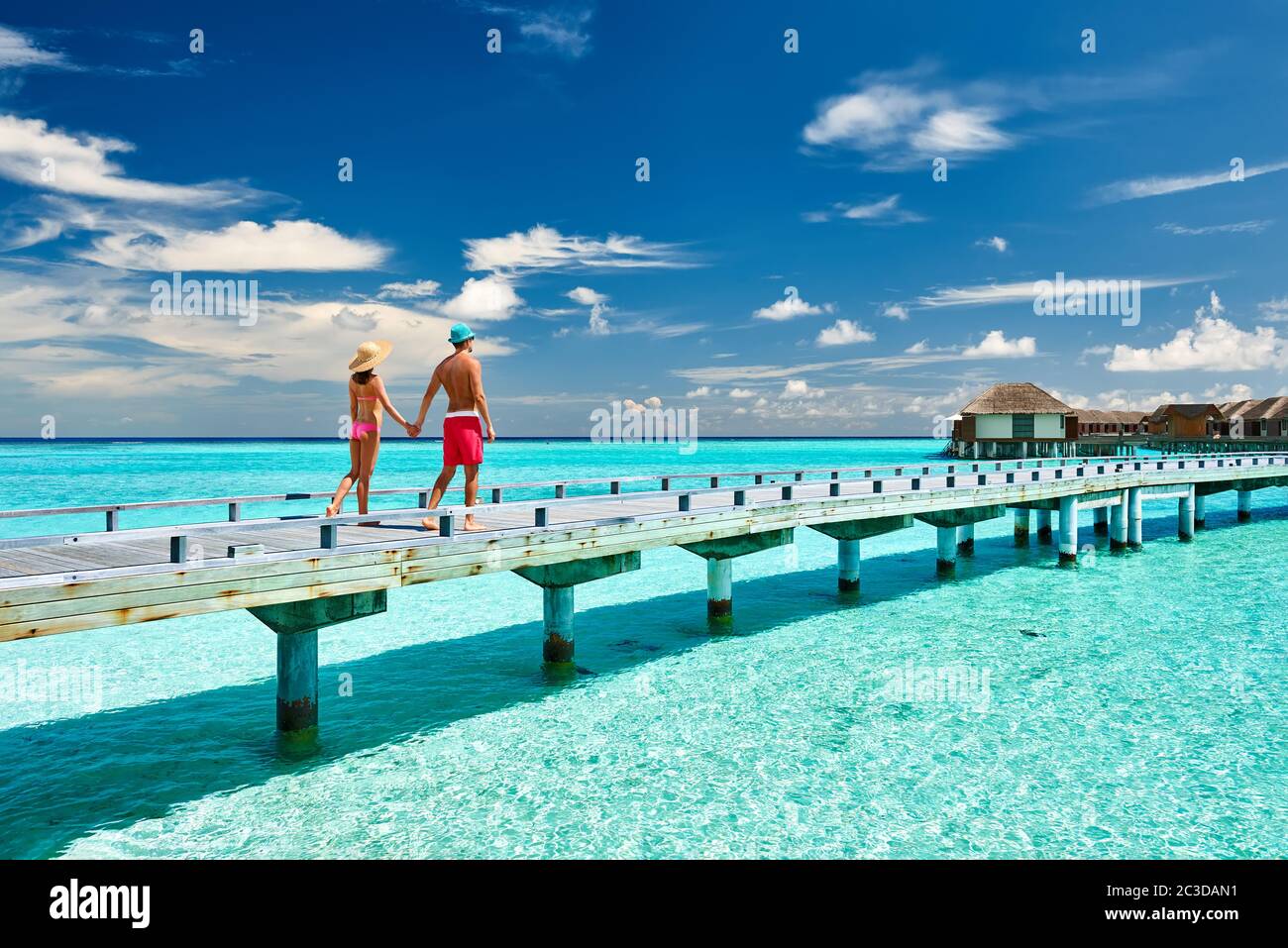 Couple on a beach jetty at Maldives Stock Photo