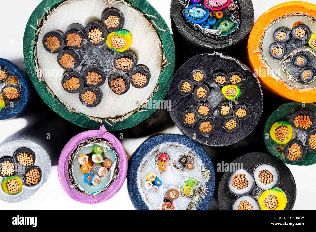 Macro photo of the cross section of various electric cables, isolated on a white background. Stock Photo