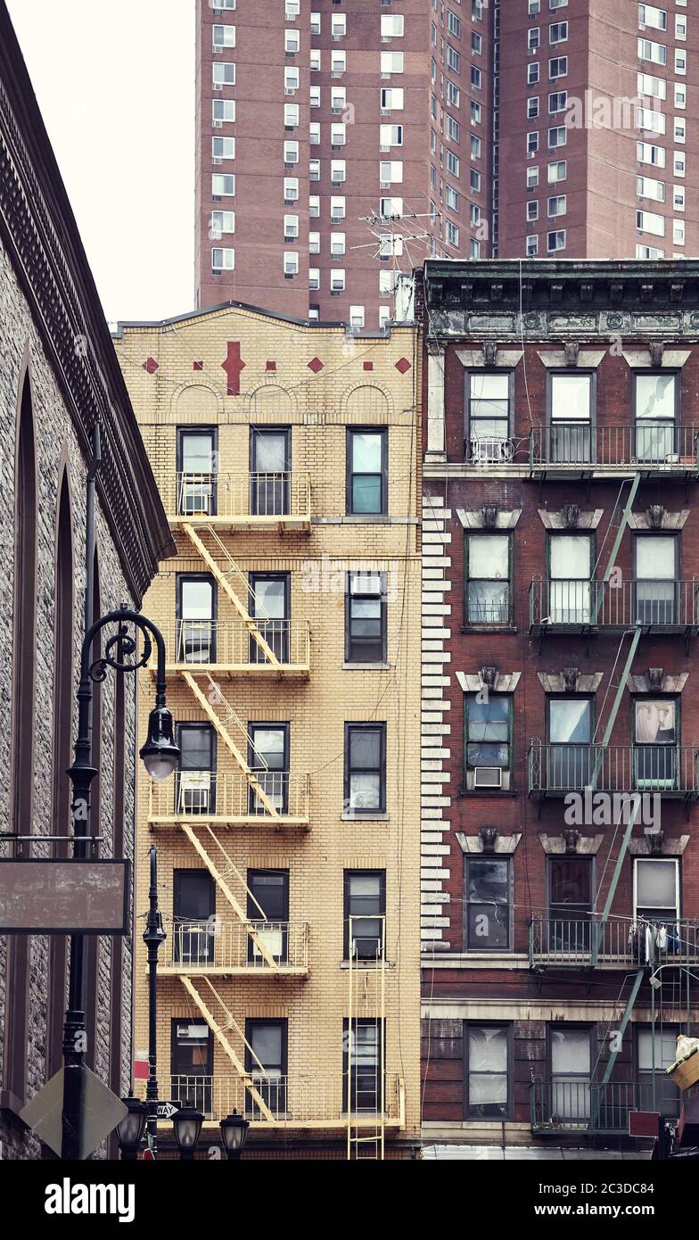 Old buildings with fire escapes in New York City, color toned picture, USA. Stock Photo