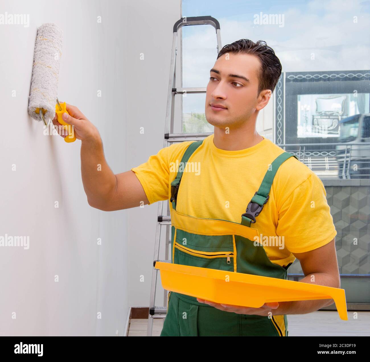 Man painting the wall in DIY concept Stock Photo Alamy