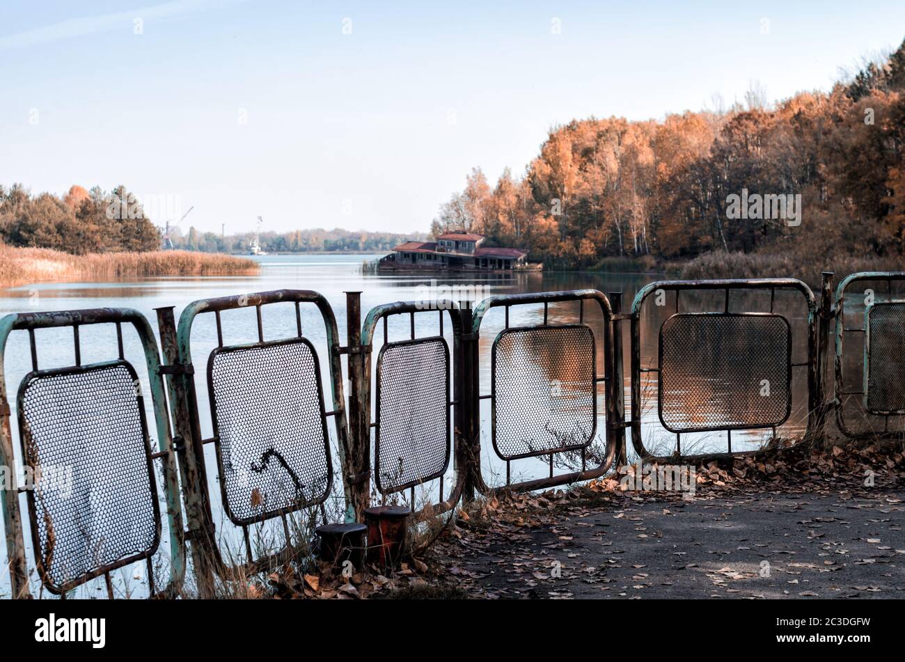 autumn landscape river and pier with a sunken house in Chernobyl Stock Photo