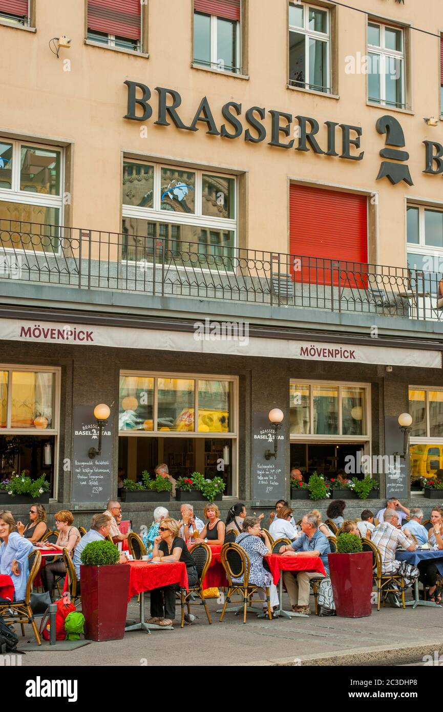 People sitting in an outdoor cafe in the market square in Basel, Switzerland. Stock Photo