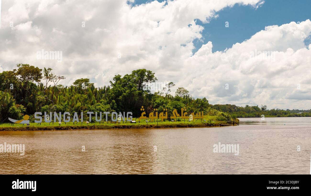 Sign 'Tutong River' in malay (Sungai Tutong) and arab language in Tutong, Brunei Darussalam. Stock Photo