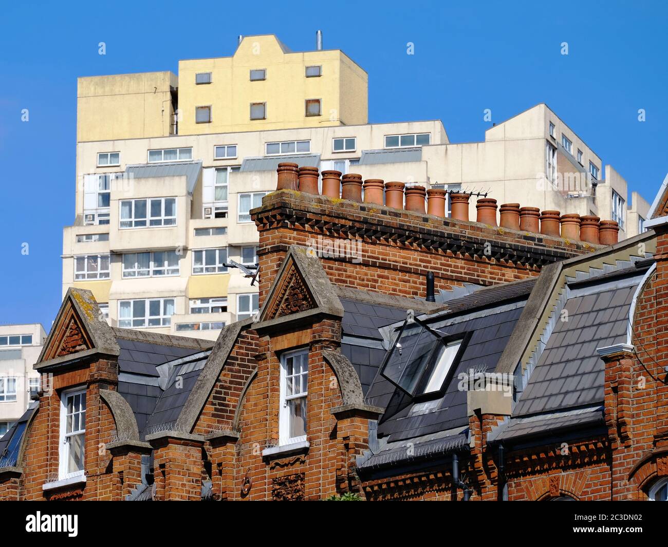 Edwardian red-brick housing Stockwell, south London with the Brutalist style towers of Beckett and Pinter house seen behind. Stock Photo