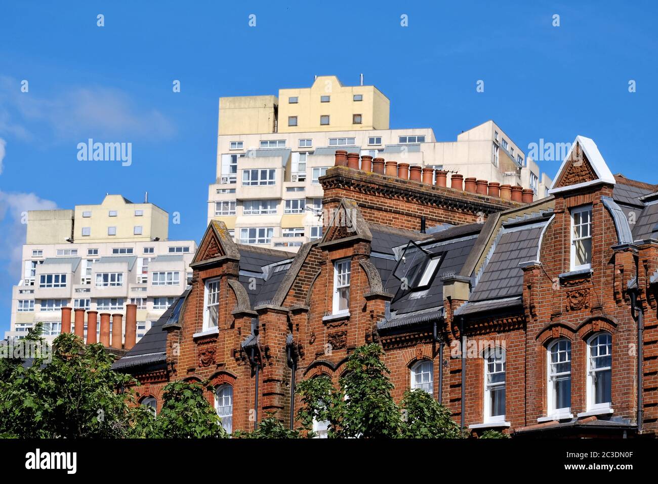Edwardian red-brick housing Stockwell, south London with the Brutalist style towers of Beckett and Pinter house seen behind. Stock Photo