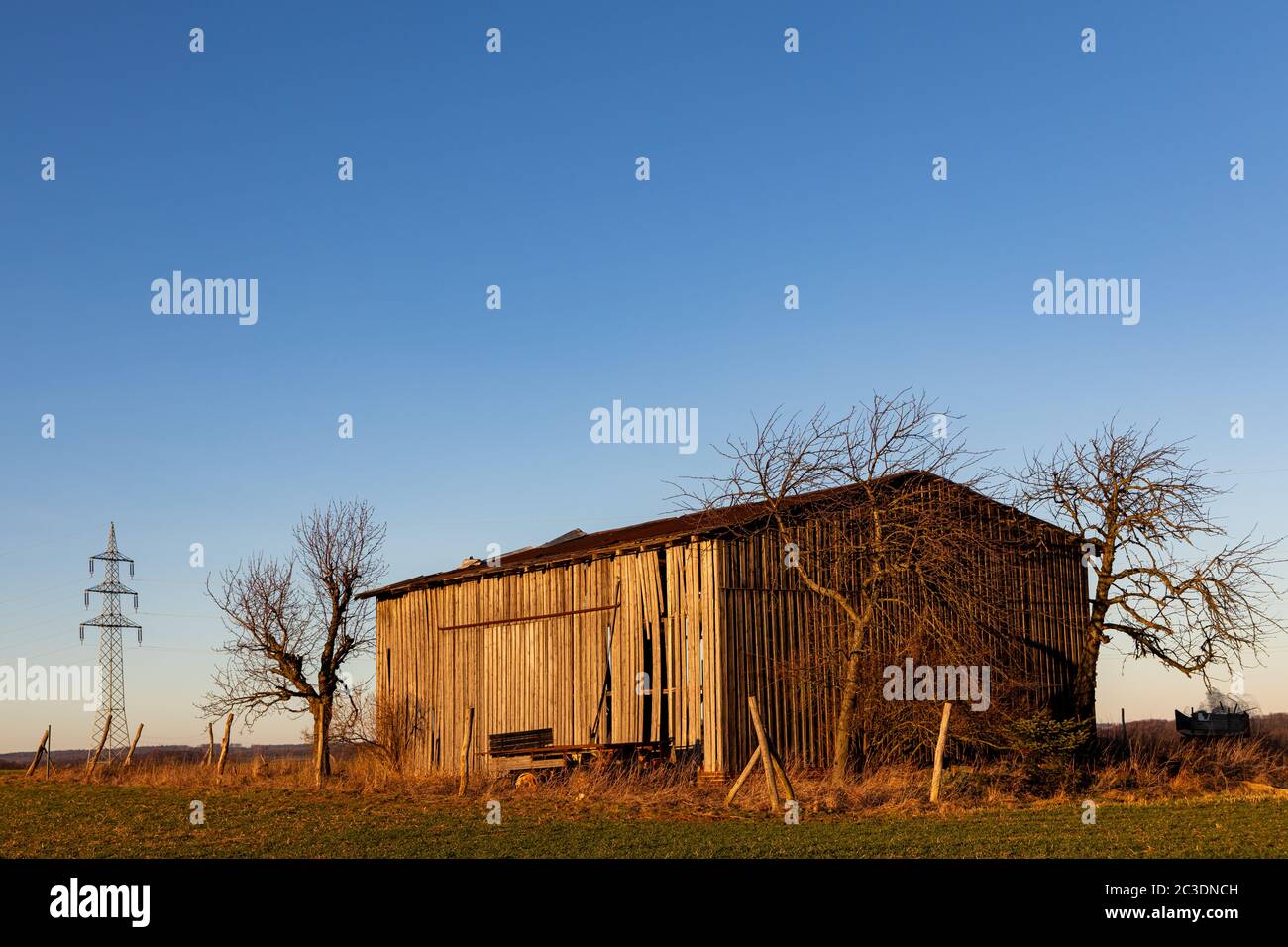Field barn at sunset Stock Photo