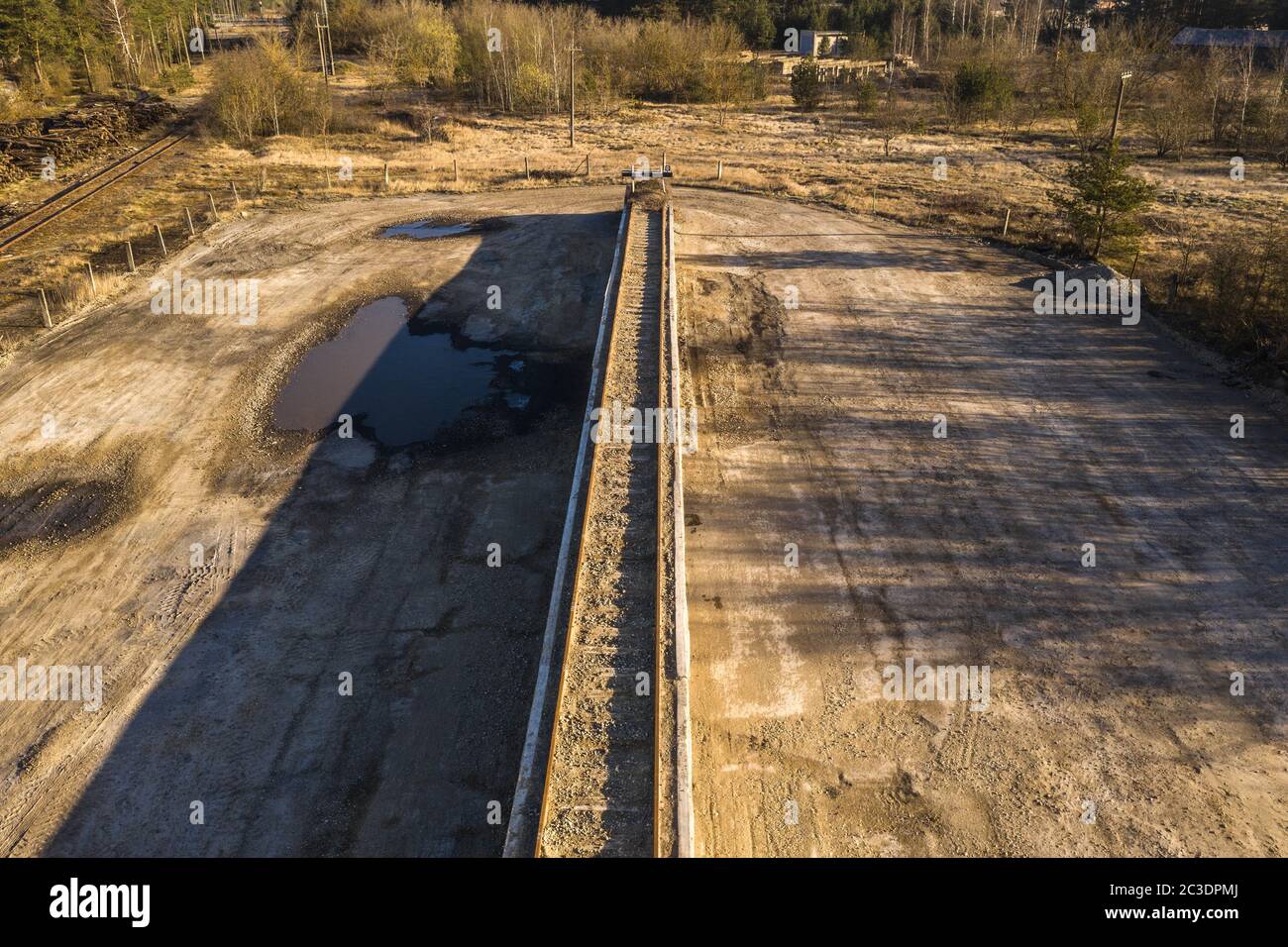 Drone view of old rusty railway track on an platform during summer day. Stock Photo