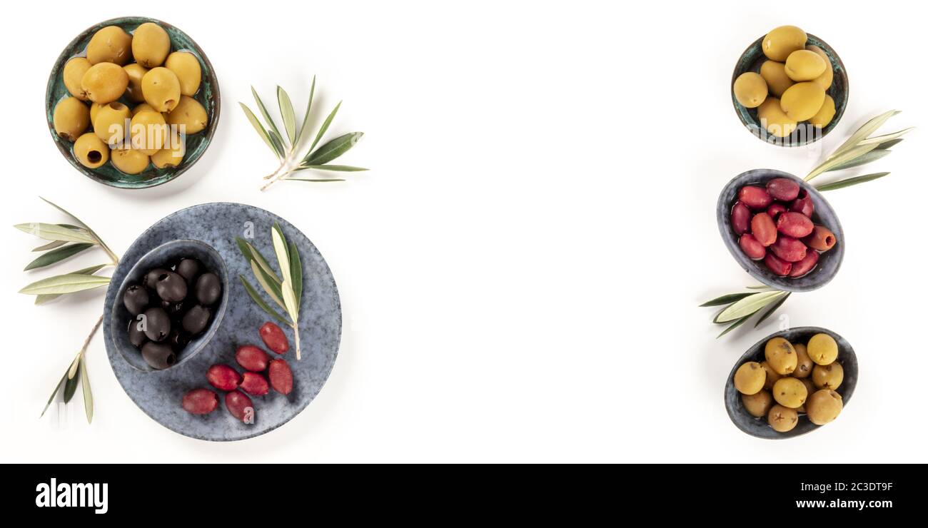 Olives flat lay panorama. Green, black and red olives, shot from the top on a white background with a place for text, a design t Stock Photo