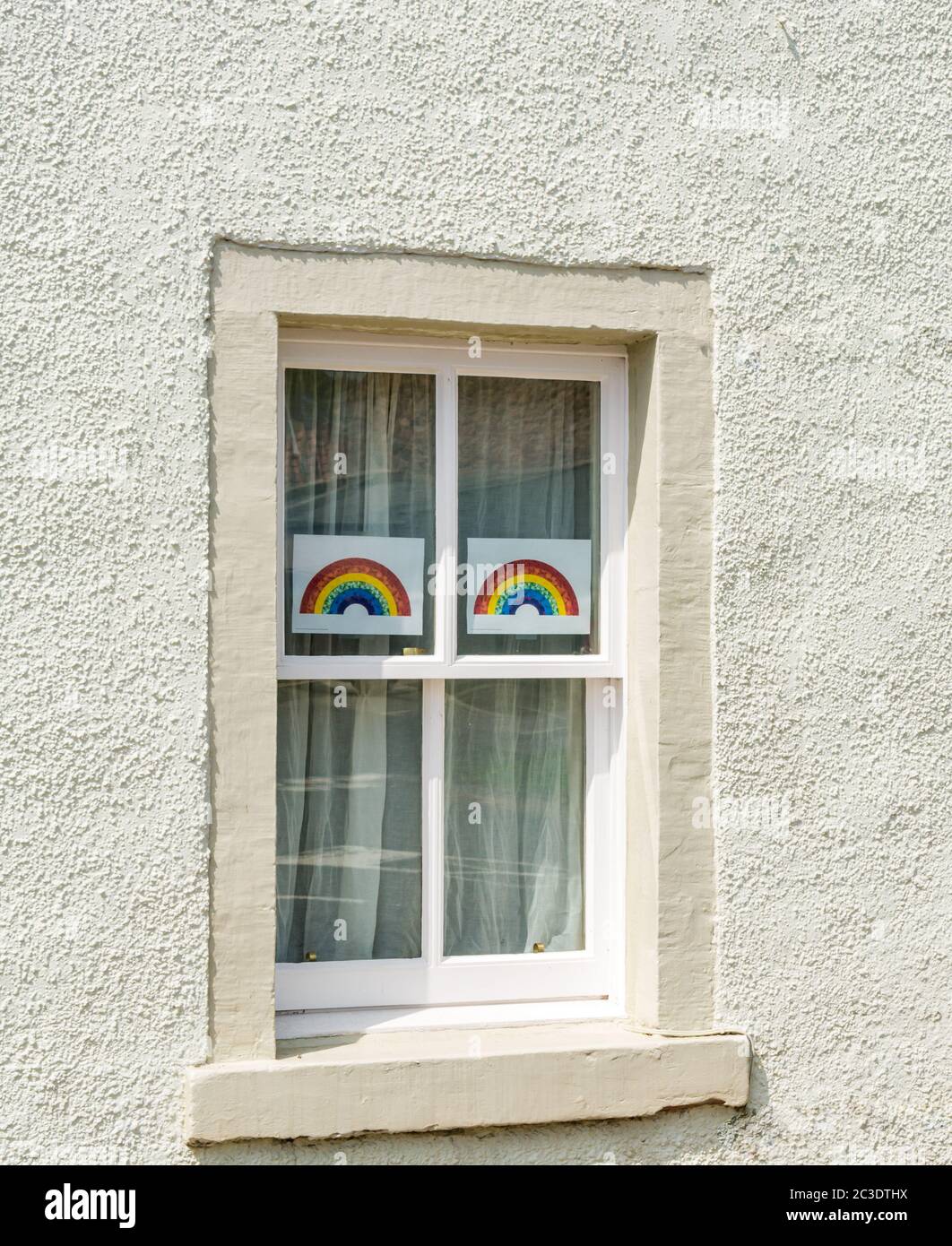Rainbow drawings in house window during Covid-9 Coronavirus pandemic as symbol of hop, Gifford, East Lothian, Scotland, UK Stock Photo