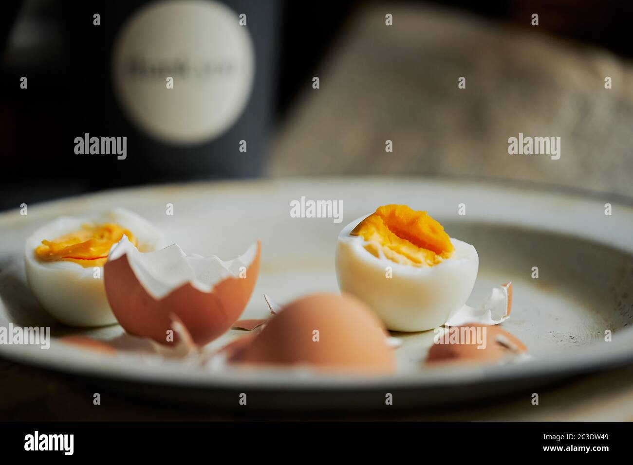 Defocused background with ready to eat eggs in vintage enamel plate. Behind blurred bacground Stock Photo