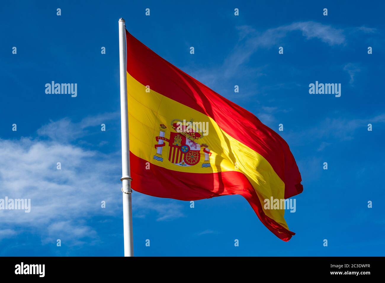 Flag of Spain over blue sky background Stock Photo