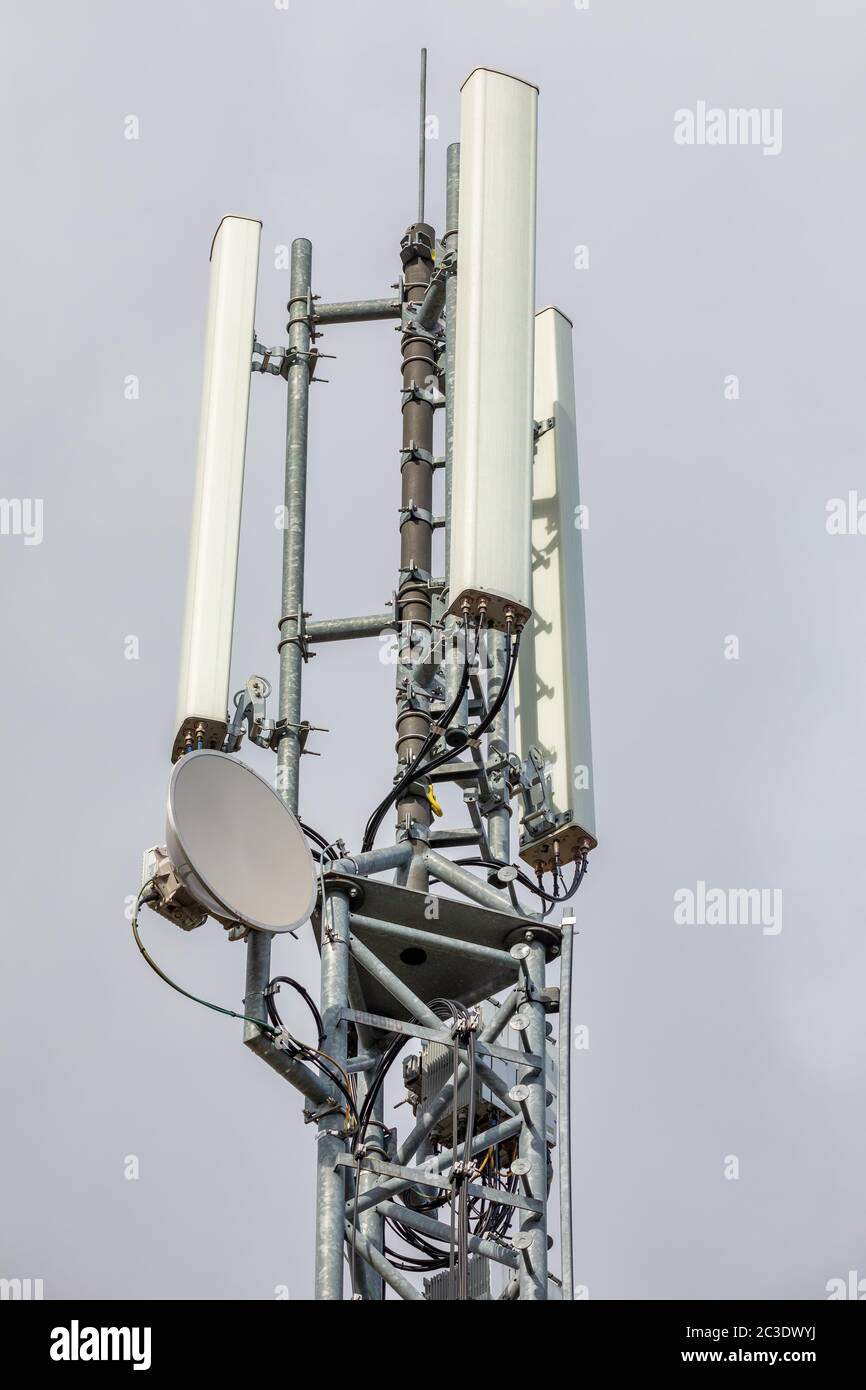 Wireless communication tower with antenna Stock Photo