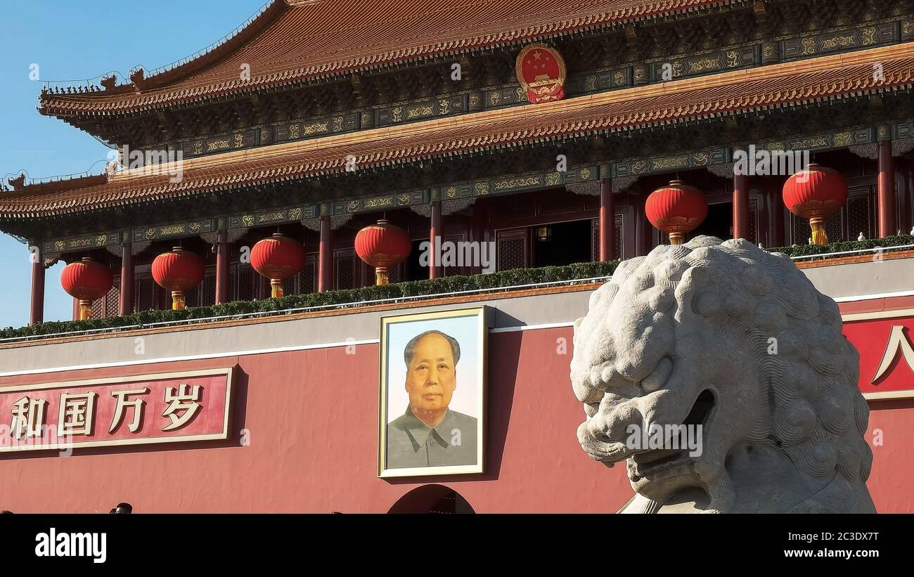 ancient stone lion close up and mao zedong portrait in tiananmen square Stock Photo