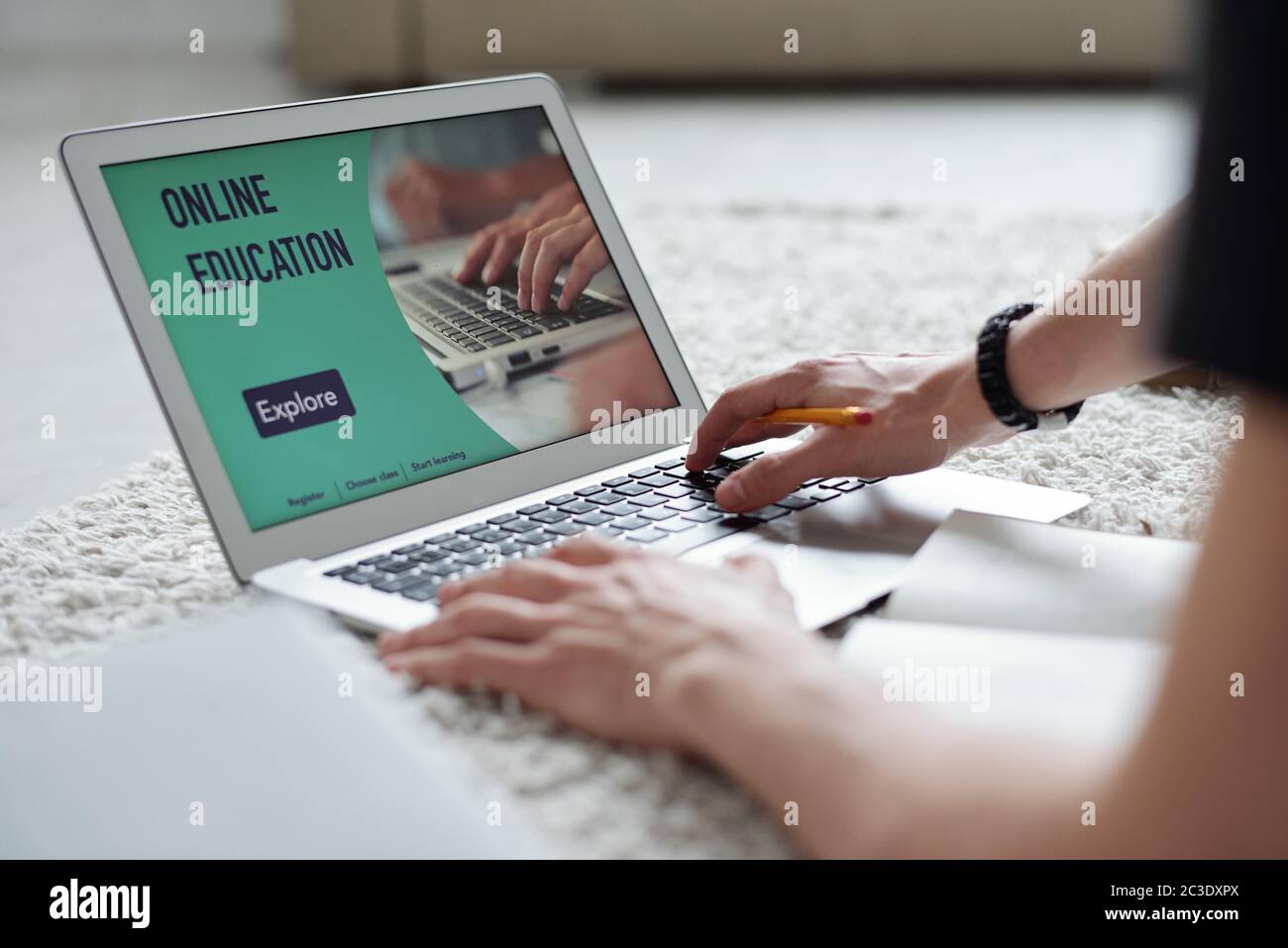 Close-up of unrecognizable student using laptop while taking online course during quarantine Stock Photo