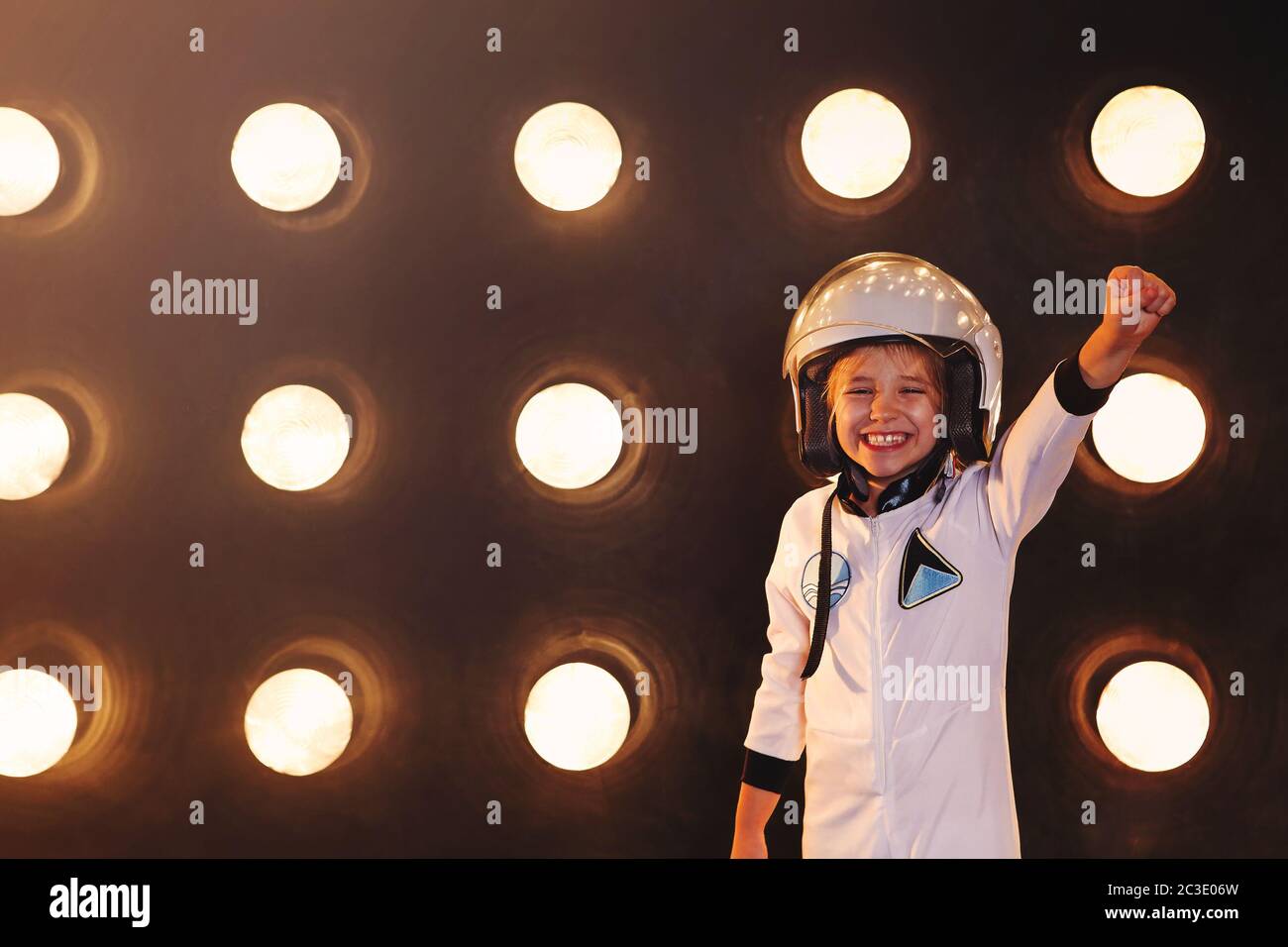 Happy confident kid in uniform pretending to be astronaut Stock Photo