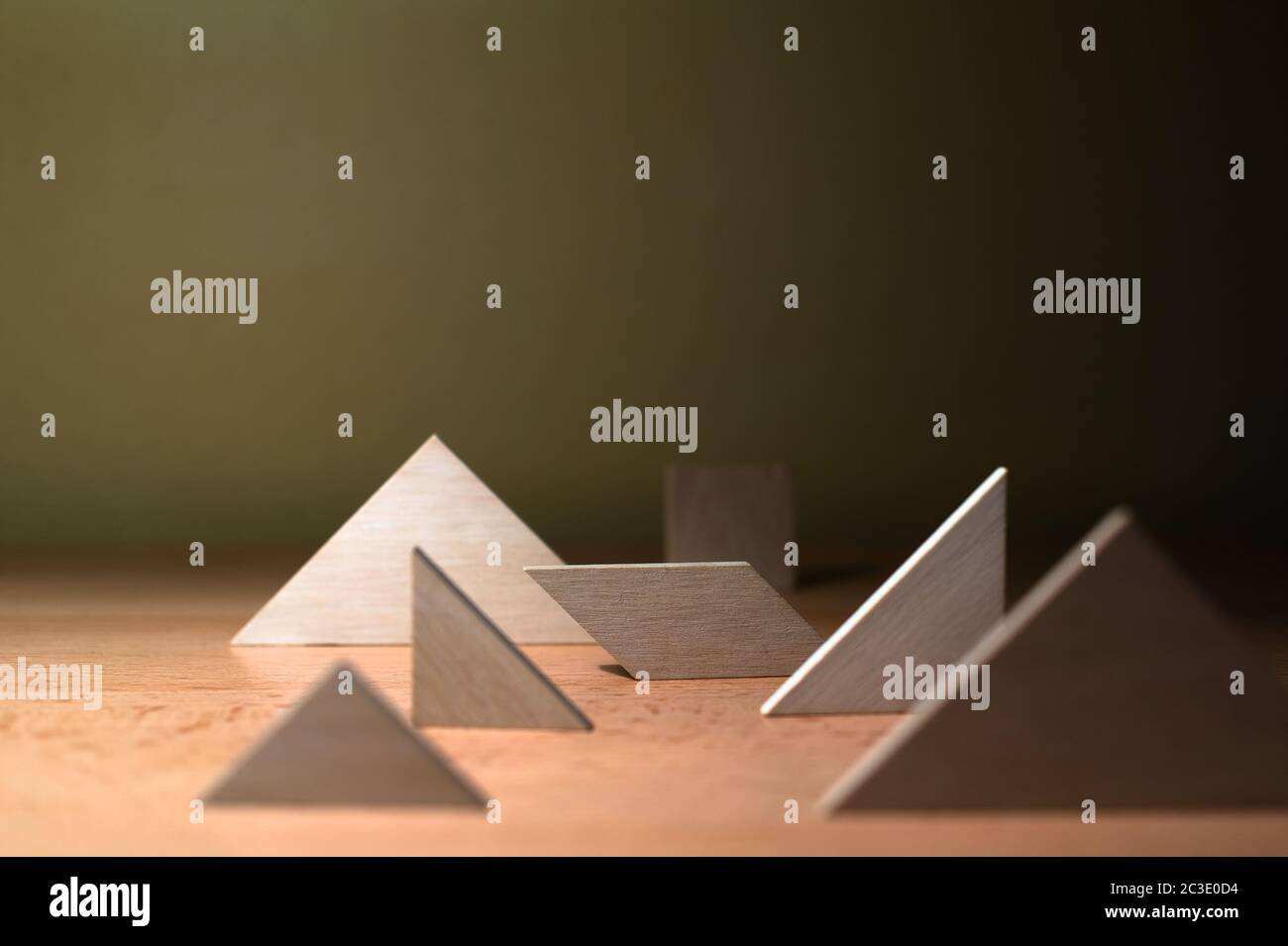 Composition of various geometrical objects - square, triangle, quadrangle - on wooden desk. Shallow depth of field and focus Stock Photo