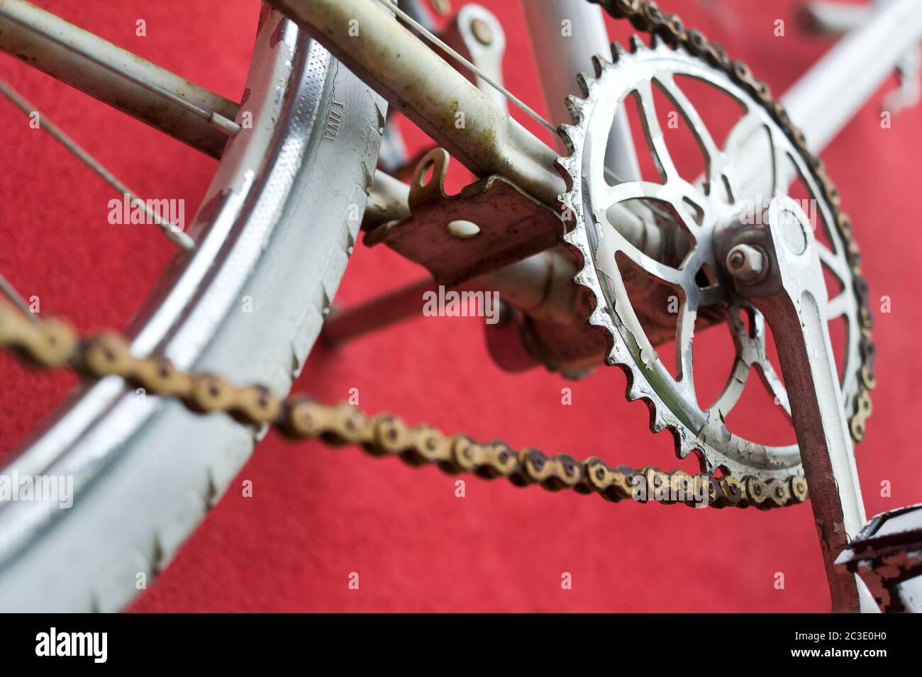 Detail of old road bike crankset, pedal on colorful red background