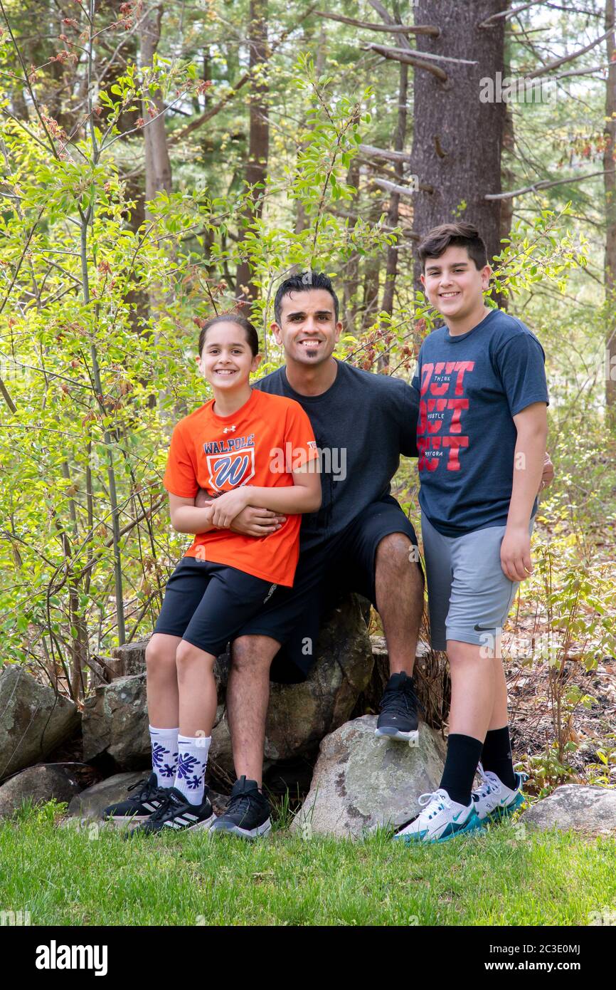 Puerto Rican graphic designer David Torres and his two children at home during Covid, Walpole, MA Stock Photo
