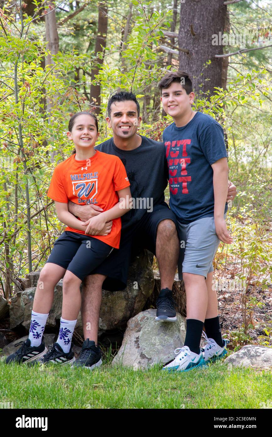 Puerto Rican graphic designer David Torres and his two children at home during Covid, Walpole, MA Stock Photo