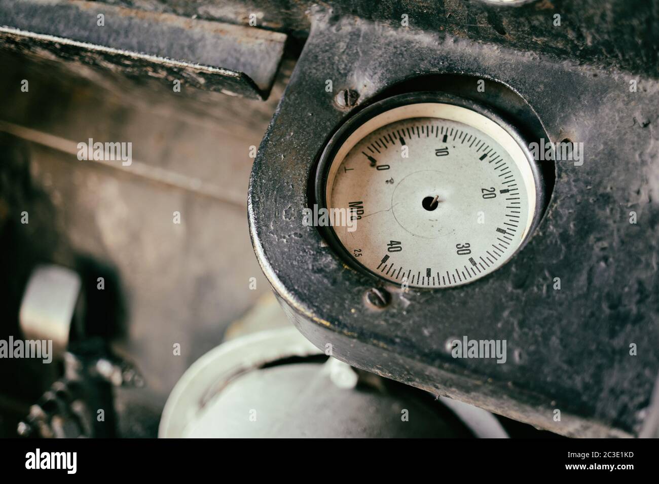 Old abandoned industrial engine. Detail of non-working pressure dial without needle Stock Photo