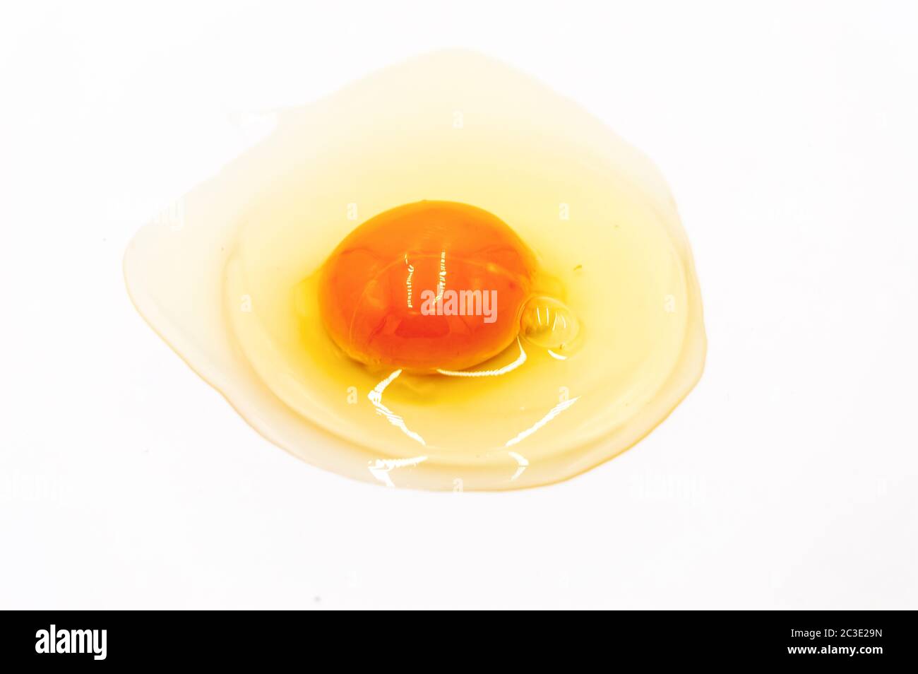 Egg yolk and white on white background Stock Photo