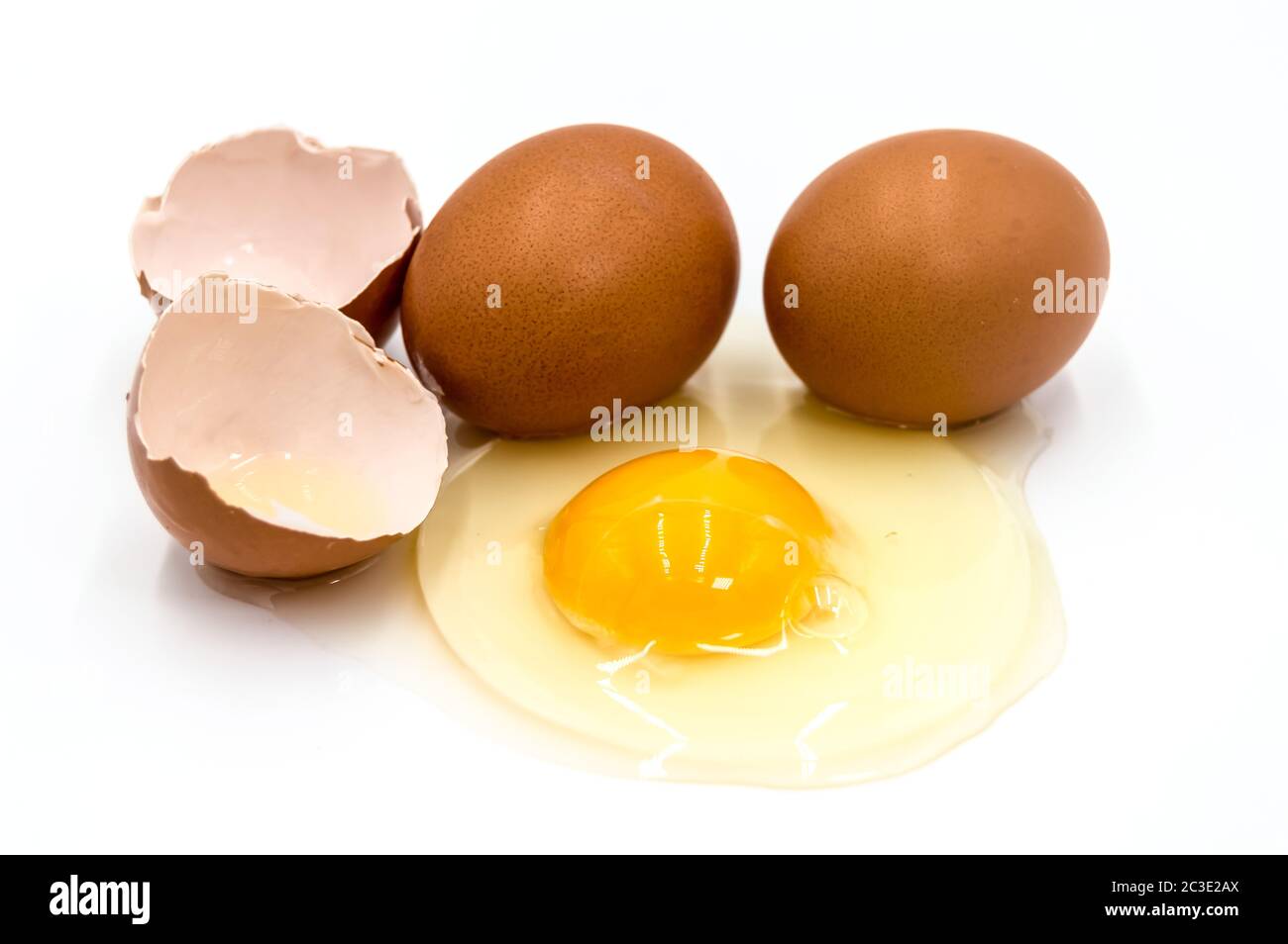 Egg yolk and white on white background Stock Photo