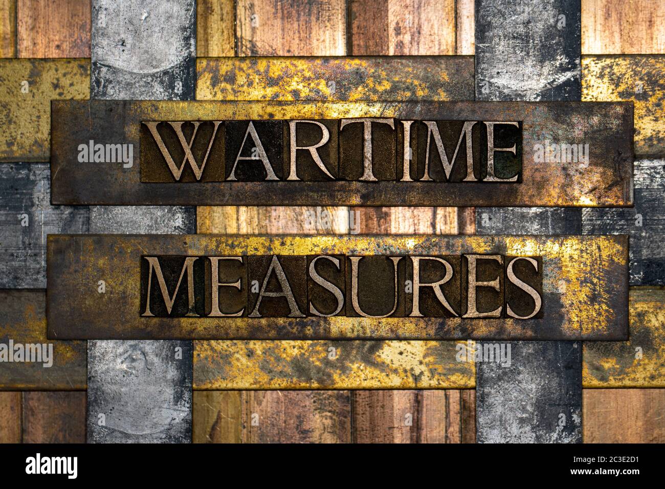 Wartime Measures text formed with real authentic typeset letters on vintage textured silver grunge copper and gold background Stock Photo