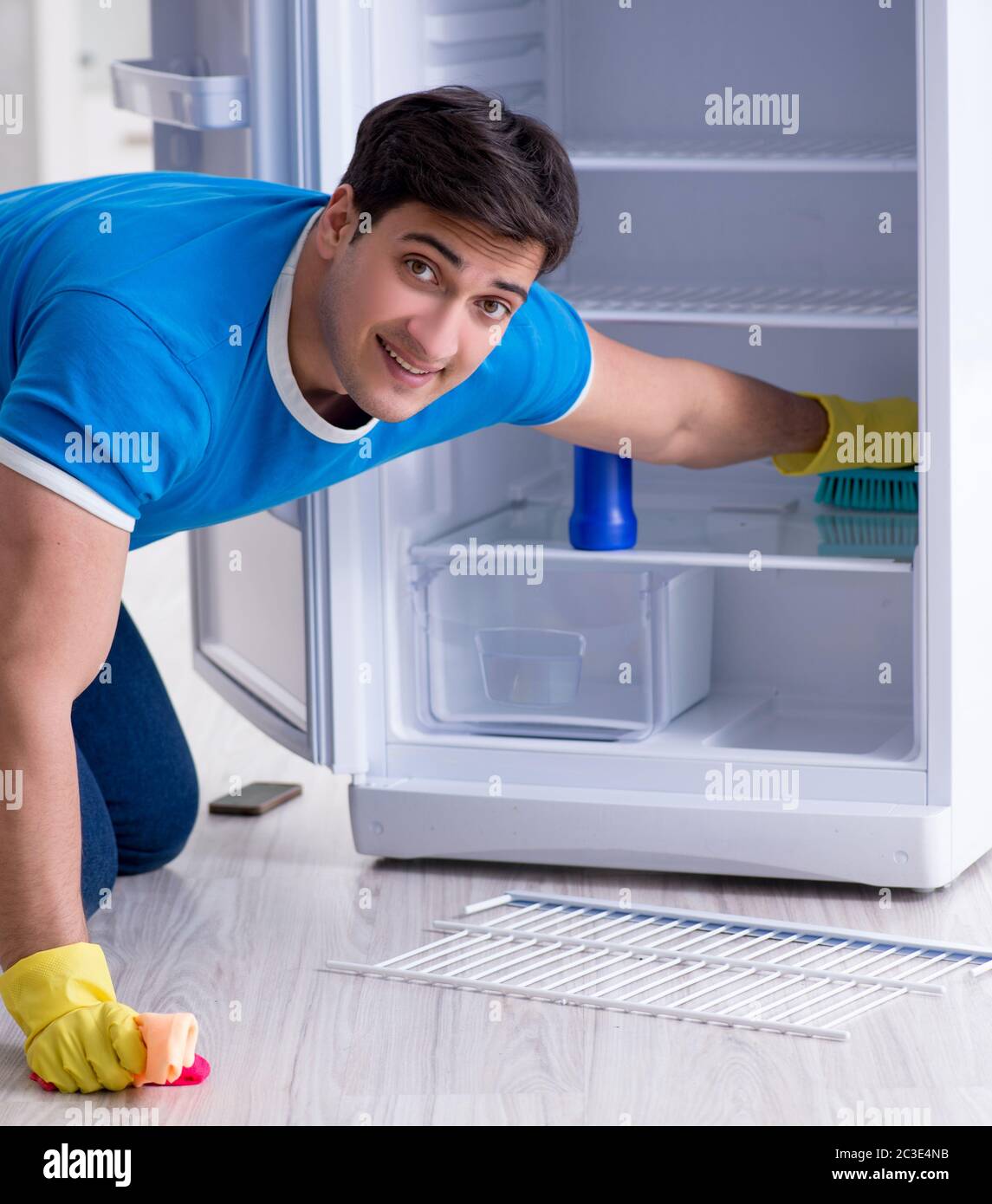 Man cleaning fridge in hygiene concept Stock Photo - Alamy