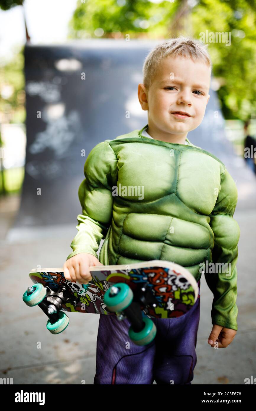 Boy with a skate in a skate park. In a superhero costume. Stock Photo