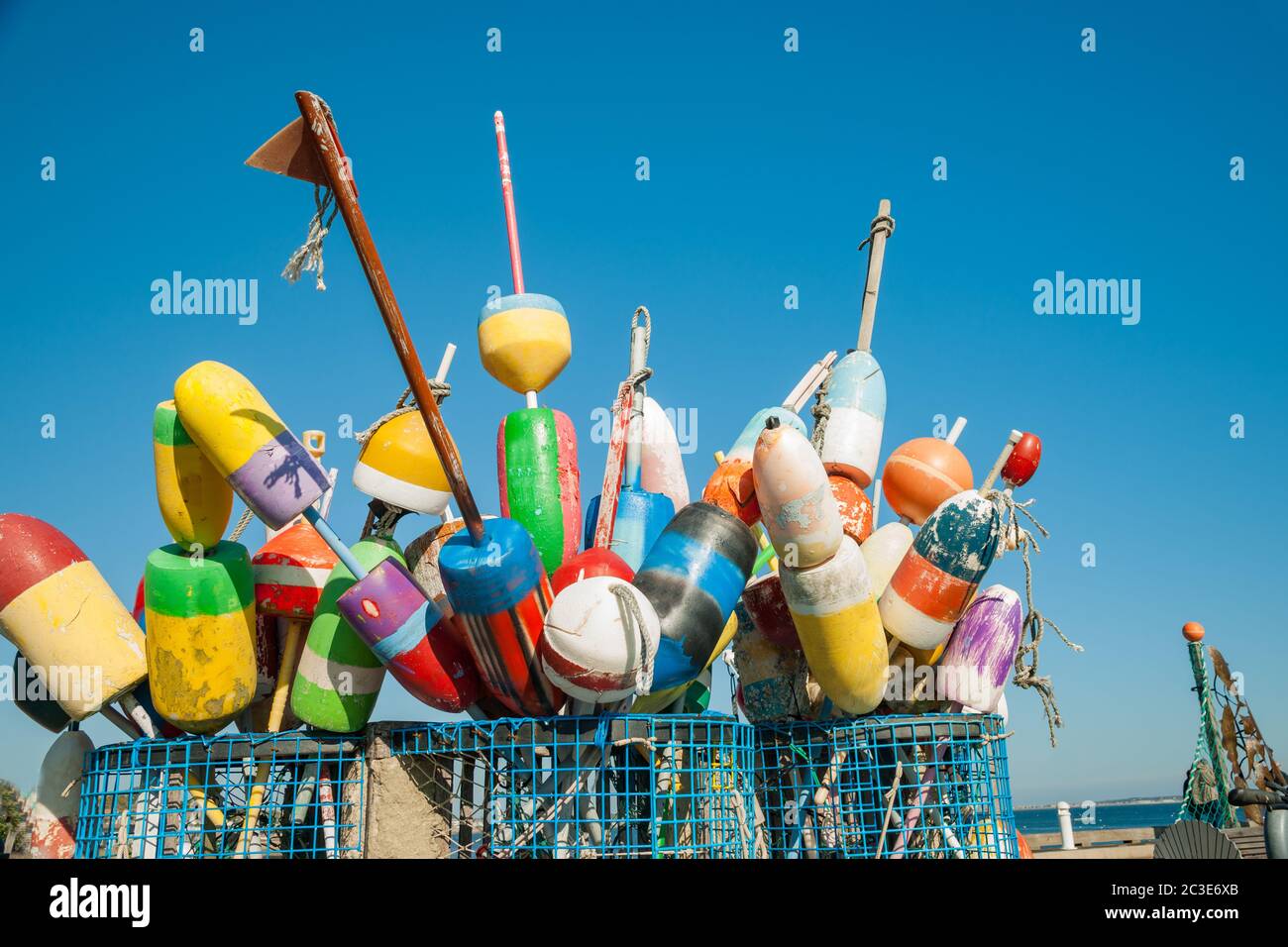 Collection of colorful fishing or lobster trap buoys and markers at wharf in Provincetown