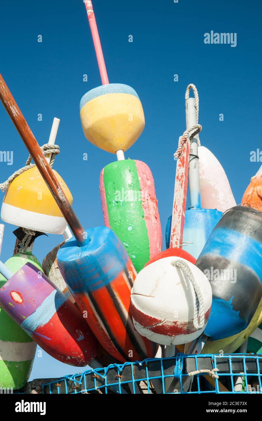 Collection of colorful fishing or lobster trap buoys and markers at wharf in Provincetown