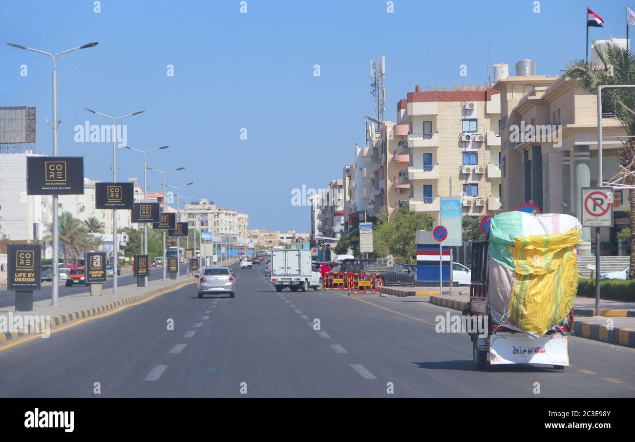 City panorama with street cars about buildings in Hurghada. Modern city with cars on highway. Stock Photo