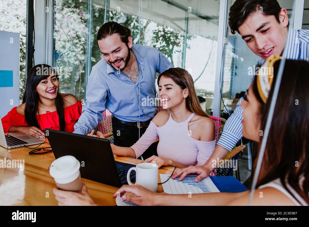 young mexican people or creative team working with laptop at office or coworking place in Mexico city Stock Photo