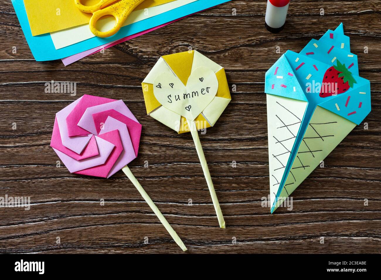 Origami paper ice cream and lollipop on a wooden table. Children's art  project, handmade, crafts for children Stock Photo - Alamy