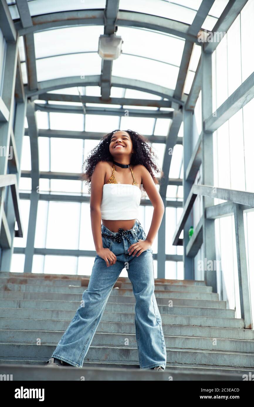 young cute teenage african girl in industrial zone happy smiling having  fun, big city lifestyle fashion people Stock Photo - Alamy