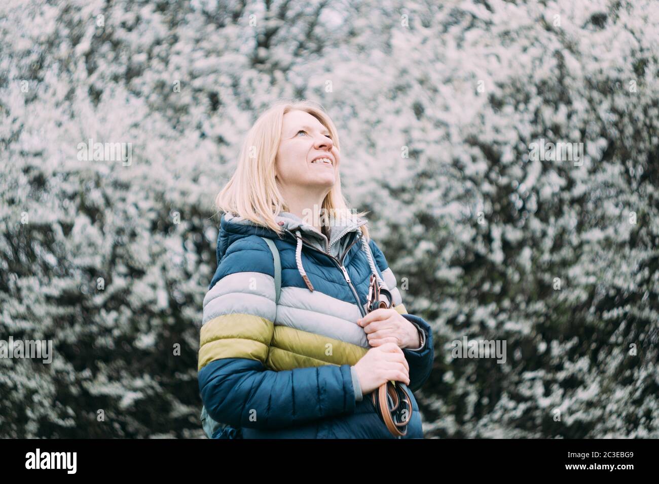 Authentic smiling blonde woman. Retro analog vintage swirley bokeh film look. Real middle aged peopl Stock Photo