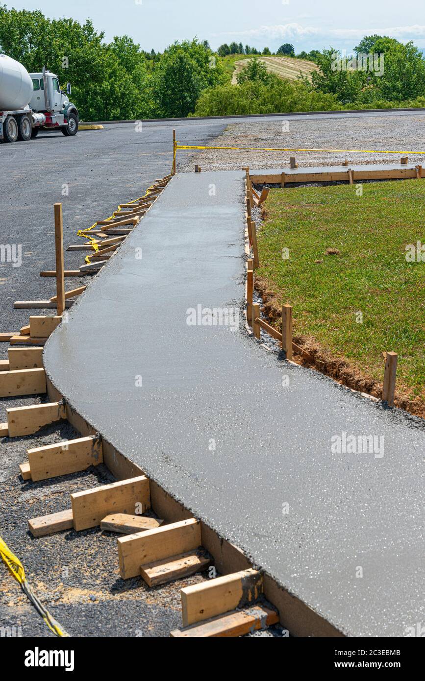 Vertical shot of a freshly poured concrete sidewalk. Stock Photo